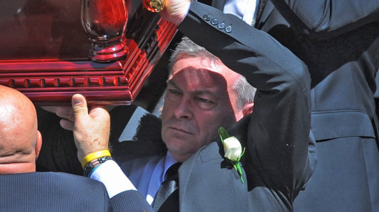 Borce Ristevski carries his wife's coffin at her funeral in March 2017.