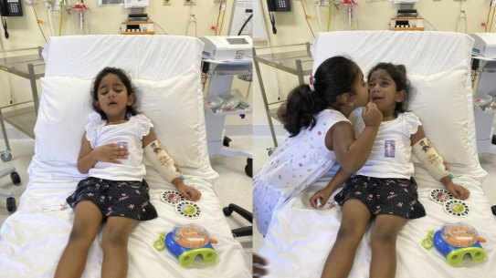 Tharnicaa and her sister Kopika in hospital on Christmas Island on June 6.  