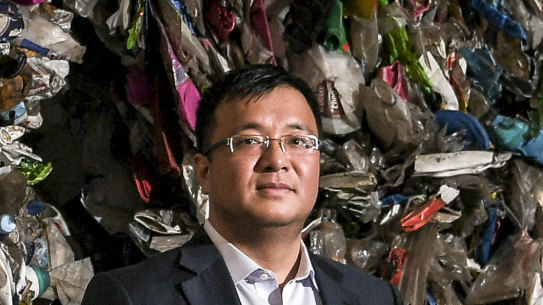 Harry Wang with a wall of plastics ready for recycling at his Advanced Circular Polymers plant in Somerton.