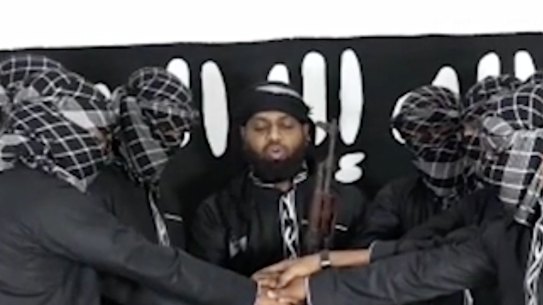 Image posted by Islamic State purports to show attackers in Sri Lanka standing before the terror group's flag. 