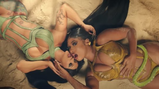 Cardi B, left, with fellow rapper Megan Thee Stallion, seen here in a still from their video for Cardi B's single, WAP,  ignited a social media firestorm about sexual double standards.