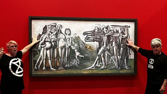 Protesters glue themselves to a Picasso painting at the NGV. 