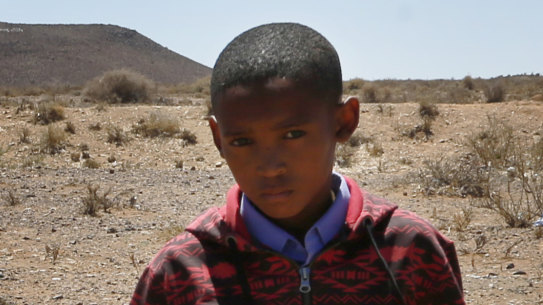 Children carry a dead lamb belonging to small scale farmer Gertruida Buffel in Vosburg, South Africa. 