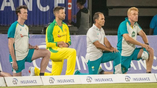 The Australian team takes a knee before a T20 clash with the West Indies.