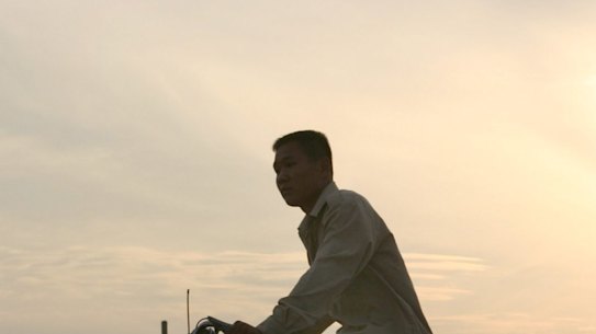 A cyclist passes by oil wells at sunset at Sinopec's Shengli Oil Field in China's Shandong Province June 26, 2003. Oil refiners and traders in Asia may have shipped as much as 500,000 metric tons of gasoil, or diesel, in a month to South America and the U.S., where rising demand for the fuel is helping to sap excess supplies from the Asian region. Photographer: Kevin Lee / Bloomberg News man on bike / bicycle