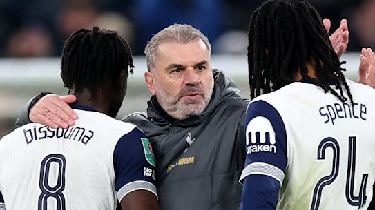 Ange Postecoglou celebrates with his players.