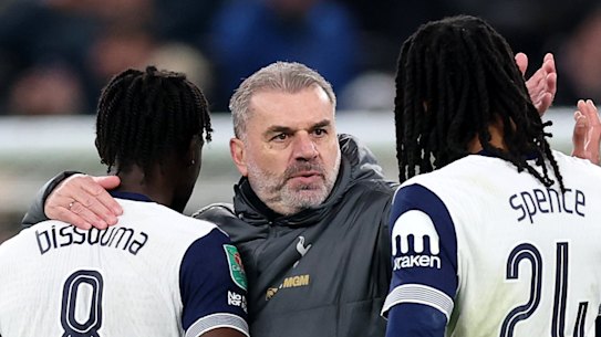 Ange Postecoglou celebrates with his players.