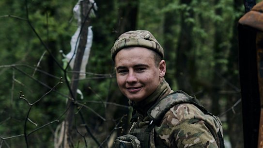 A Ukrainian soldier rests on a burned vehicle on the frontline in Bakhmut, Donetsk region, on Sunday April 23.