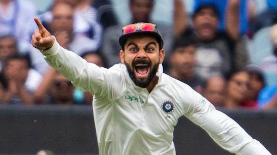 Virat Kohli celebrates Pat Cummins' wicket.