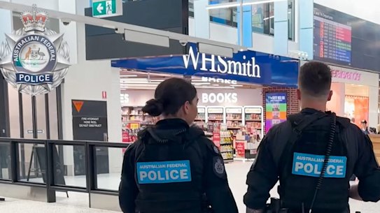 A Thai man has been arrested at Sydney Airport after allegedly punching a passenger on an international flight when a bag fell from an overhead luggage compartment and landed on him.