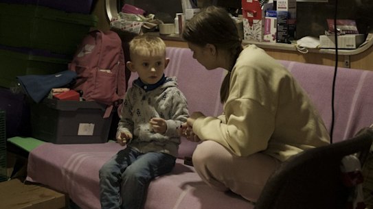 People sit inside a subway car parked in a station being used as a bomb shelter, as Russian attacks continue in Kharkiv, Ukraine.