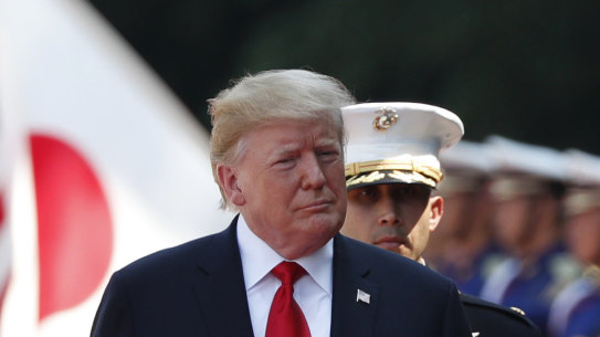 US President Donald Trump, left, inspects an honour guard during a welcome ceremony at the Imperial Palace in Tokyo, Japan, on Monday.
