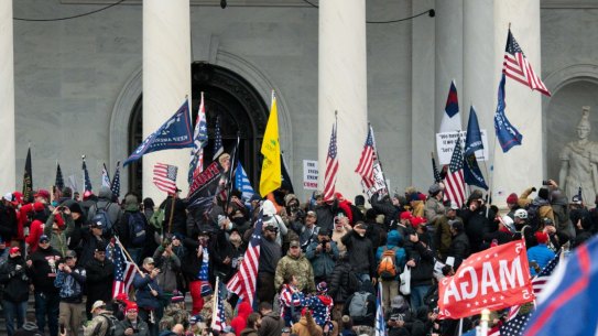 Demonstrators enter the U.S. Capitol after breaching security fencing during a protest in Washington, D.C., U.S., on Wednesday, Jan. 6, 2021. The U.S. Capitol was placed under lockdown and Vice President Mike Pence left the floor of Congress as hundreds of protesters swarmed past barricades surrounding the building where lawmakers were debating Joe Biden's victory in the Electoral College. Photographer: Graeme Sloan/Bloomberg