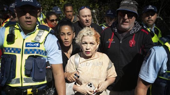 Kellie-Jay Keen-Minshull is escorted from the Auckland event by police.