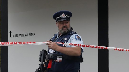 A police officer stands guard near the Masjid Al Noor mosque in Christchurch, New Zealand, Saturday, March 16, 2019, where one of the two mass shootings occurred. A white supremacist suspected in shootings at two mosques that killed 49 people during midday Friday prayers posted an anti-immigrant manifesto online and apparently used a helmet-mounted camera to broadcast live video of the slaughter on Facebook. (AP Photo/Vincent Yu)