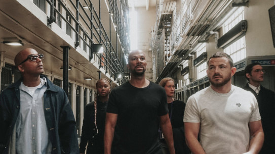 David Jassy, left, a formerly incarcerated advocate, hip hop artist Common and Imagine Justice political advisor Michael Latt tour San Quentin State Prison in California.