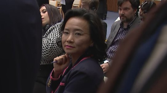 Australian journalist Cheng Lei is “flanked” by two Chinese government officials during a signing ceremony at Parliament House on Monday.