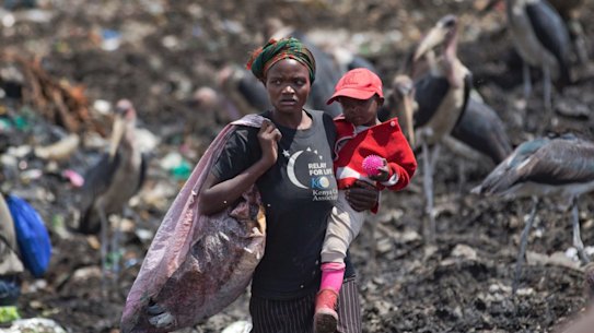 People scavenging for plastic at a garbage dump in the Dandora slum of Nairobi, Kenya, hunting for anything that can be recycled to earn themselves enough for their daily bread. 