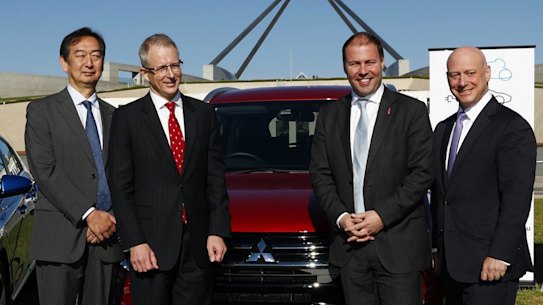 Mitsubishi CEO Mutsuhito Oshikiri, Minister for Urban Infrastructure Paul Fletcher, then- Minister for Environment and Energy Josh Frydenberg and AGL CEO Andy Vesy during an electric car event on the front lawn of Parliament House in May 2017.