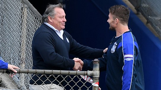 Costly shake? Bulldogs legend Terry Lamb greets Kieran Foran before training on Thursday.