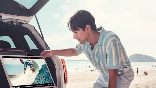 Just drive your car right onto the beach to watch some surfing videos from your boot.