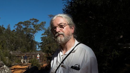 Peter Turner, from the National Parks Association of NSW, examines iron contamination of the Eastern Tributary, in the Woronora catchment area, south of Sydney. A coal mine underneath the area is blamed for creating cracks that reach the surface, exposing water to additional minerals.
