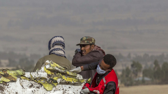 Rescue workers comb the scene of the Ethiopian Airlines crash.