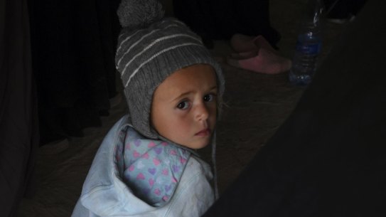 An Australian child sits on the ground of one of the tents amongst other Australian women and children in al Hawl camp in North East Syria. There are 20 Australian women and 46 Australian children detained in al Hawl camp for their association with Islamic State fighters. They are living in squalid conditions and are afraid of the war that started when Turkey invaded the Kurdish region known as Rojava in North East Syria, Syria. 21st October, 2019. Photo: Kate Geraghty/SMH