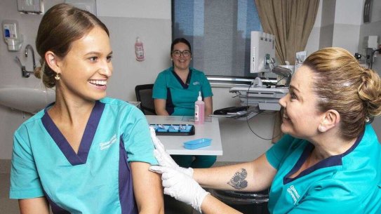 Queensland nurse Zoe Park receives a COVID-19 vaccination from Kellie Kenway at Gold Coast University Hospital on Monday,