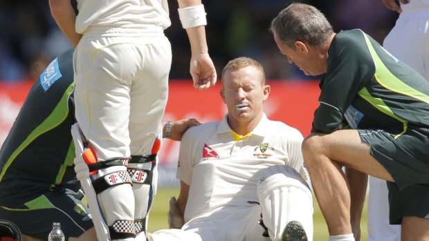 Australian medical staff attend to Rogers, who retired hurt.