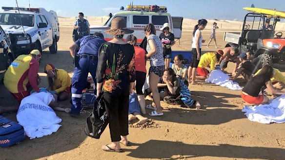 Five swimmers were pulled from a rip by local surfers.