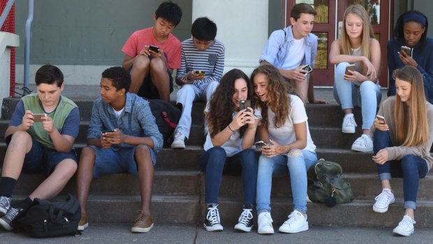 Obsessed with their phones: Teenagers in <i>Screenagers</i>.