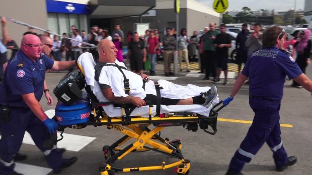 A victim is taken away after the shooting at Bankstown Central Shopping Centre.