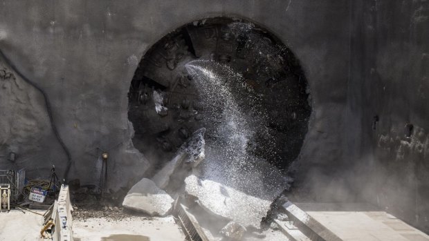 A giant boring machine named Florence bursts through rock at Cherrybrook in Sydney's north west on Thursday. 