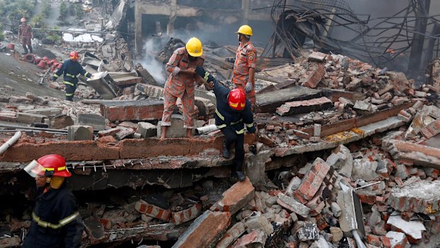 Rescue personnel work at the site of the factory fire. 