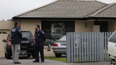 Police outside a house in Hallam during the Melbourne counter-terrorism raids.