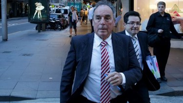 Sydney accountant Timothy Trumbull (left) leaves the ICAC hearing.
