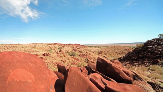 The country of the Burrup Peninsula, with petroglyph, or rock art, in the foreground.