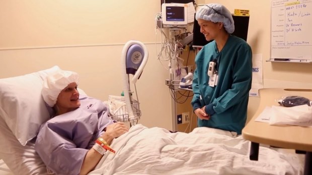 Kate (formerly Bill) Rohr chats with a nurse prior to surgery.