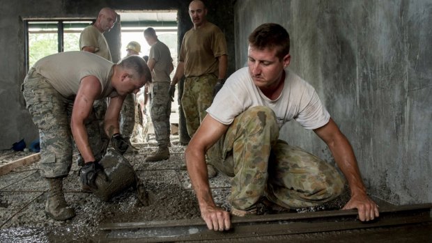 US airmen and Australian soldiers pour floor concrete during Balikatan 2017 in Ormoc City, Leyte. 