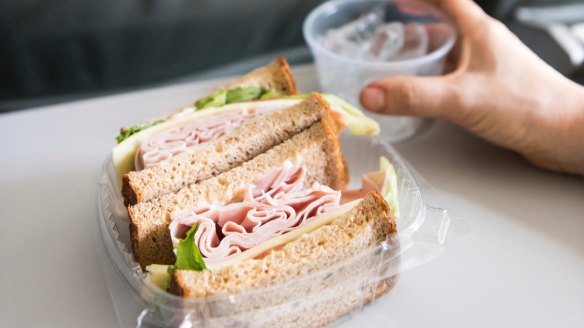 Turkey sandwich on an airplane seat tray.