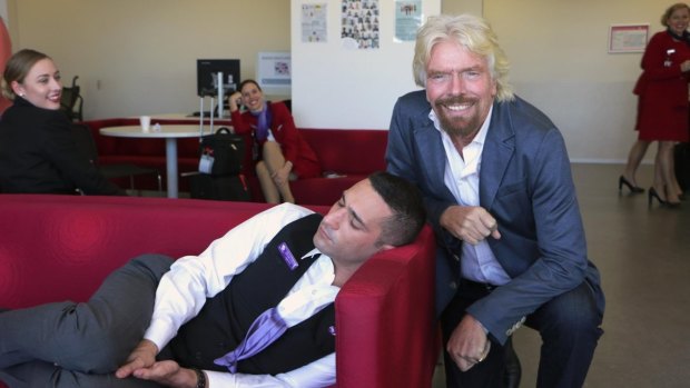 Power nap: Richard Branson and the exhausted Virgin Australia staffer.
