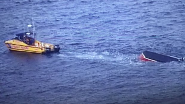 A boat has overturned near North Stradbroke Island with 11 people onboard.