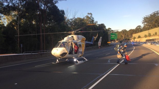 A CareFlight medical team arrives at the scene of the crash on the M2
