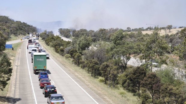 Smoke shrouds the Hume Highway at Goulburn as a grass fire burns out of control.