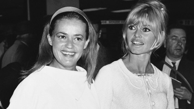 Jeanne Moreau, left, and Brigitte Bardot arrive at Orly airport in Paris in 1965.