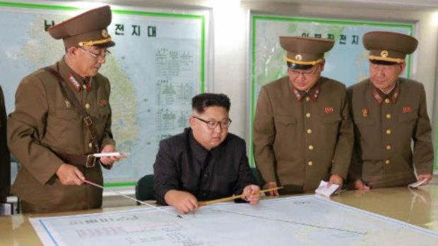 Kim Jong-un consults maps of proposed missile launches to Guam, in this image published by North Korean state media.