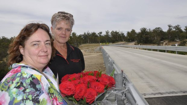 Melissa Pearce and her sister-in-law Sue Ellen Hughes pay tribute to James Hughes, who died in an October motorcycle accident on the approach to Oallen Ford Bridge.