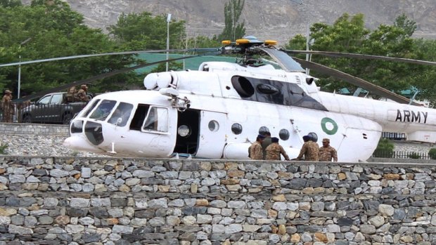 Pakistani soldiers gather beside an army helicopter at a military hospital where victims of a helicopter crash were taken for treatment in Gilgit.