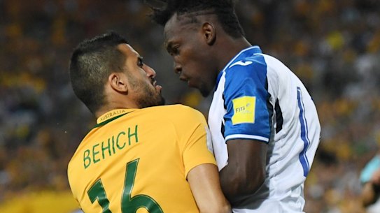 Australia's Aziz Behich (left) argues with Alberth Elis of Honduras.